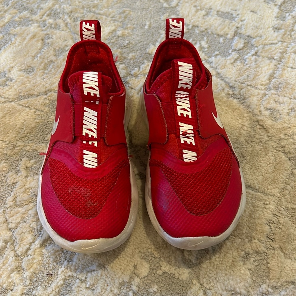 Kids red Nike tennis shoes